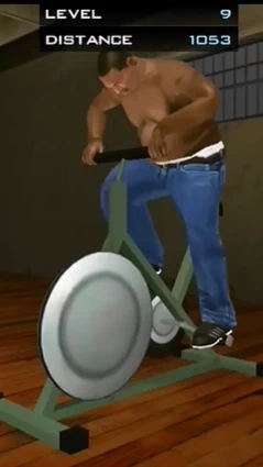 CJ working out on an exercise bike in a gym.
